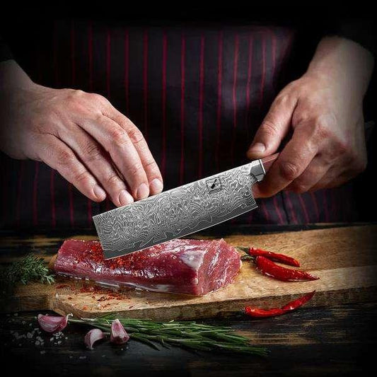 A cook cuts meat with a Damascus knife
