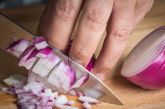 cutting onion with a chef knife